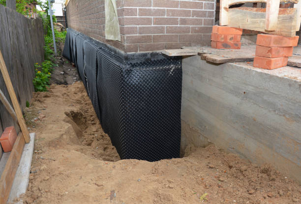 Happy homeowners after waterproofing job in Scott